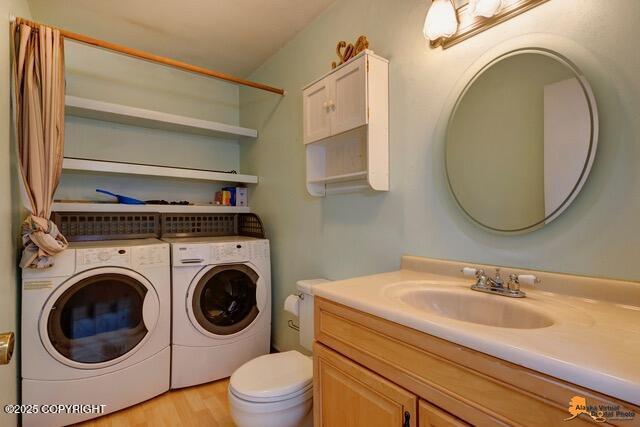 7750 Boundary Ave # A3, Anchorage, AK 99504 - bathroom with washer and dryer, vanity, and wood finished floors