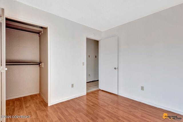 7750 Boundary Ave # A3, Anchorage, AK 99504 - unfurnished bedroom with light wood-type flooring and a closet