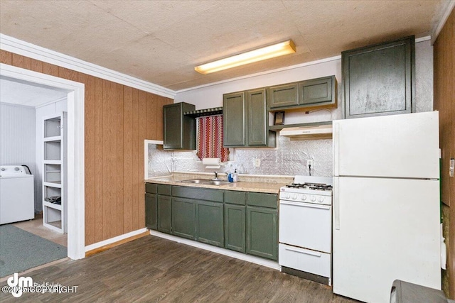 kitchen with white appliances, washer / dryer, sink, and green cabinetry