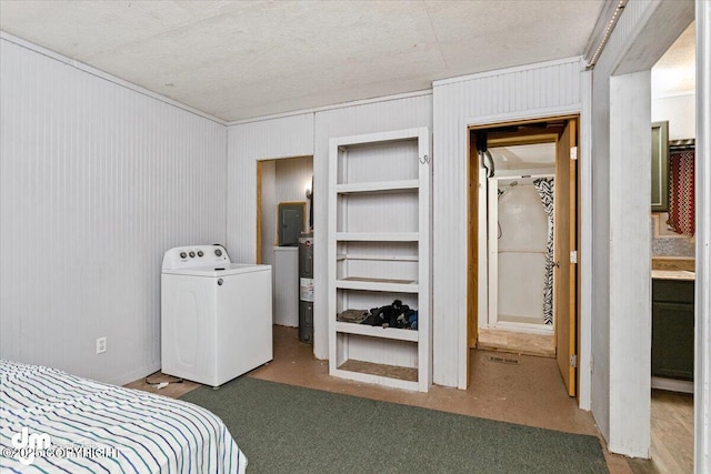 bedroom with washer / dryer, electric water heater, and a textured ceiling