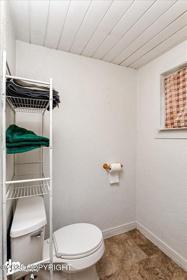 bathroom with wooden ceiling and toilet