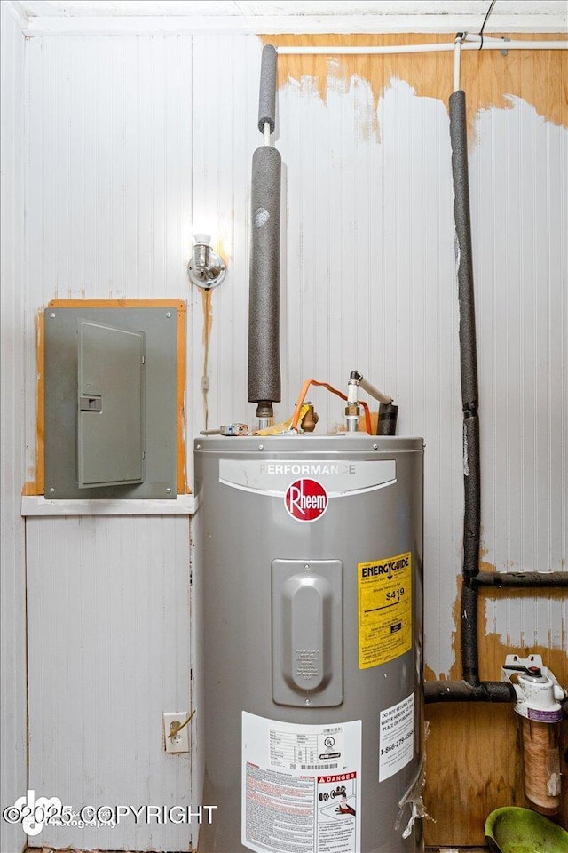 utility room featuring electric panel and water heater