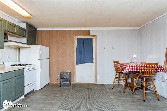 unfurnished dining area with crown molding, dark hardwood / wood-style floors, and wooden walls