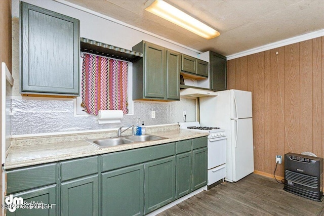 kitchen featuring sink, white appliances, wooden walls, ornamental molding, and green cabinetry