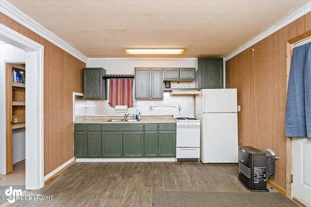 kitchen featuring ornamental molding, sink, white appliances, and wood walls