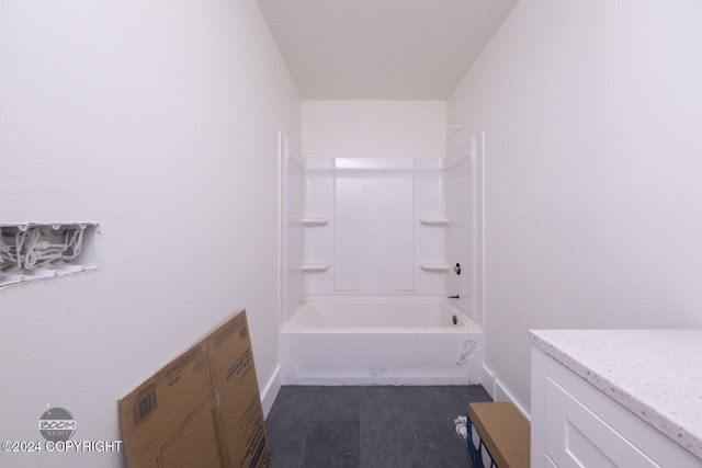 bathroom with tile patterned floors and washtub / shower combination