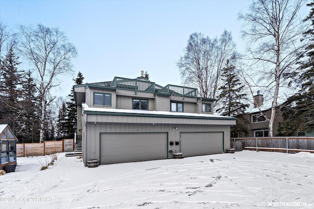 view of front of property featuring a garage and a balcony