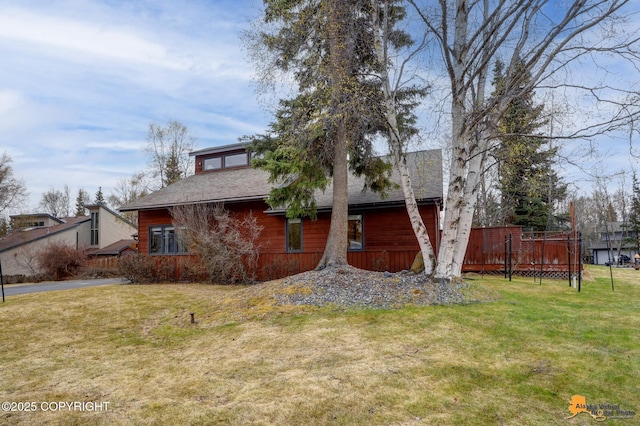 view of front of property with a front yard and a deck