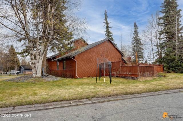 view of side of home featuring a yard