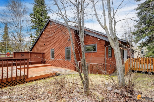 view of property exterior with a deck