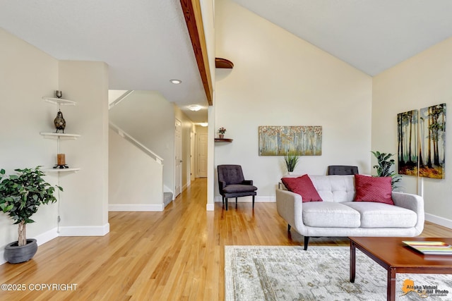 living area with baseboards, high vaulted ceiling, stairway, light wood-type flooring, and recessed lighting