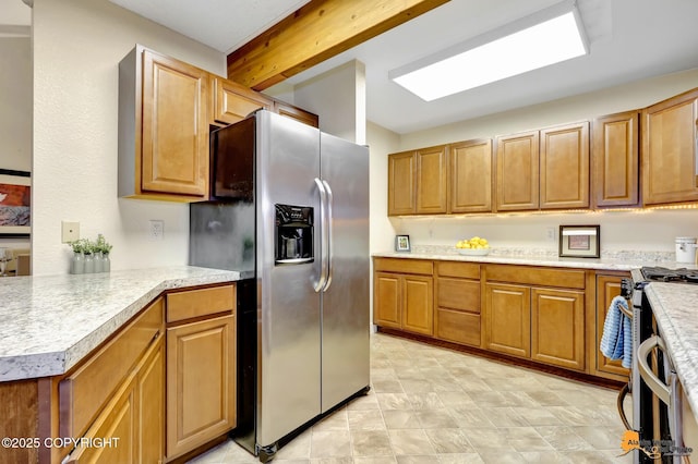 kitchen featuring light countertops, stainless steel appliances, and brown cabinetry