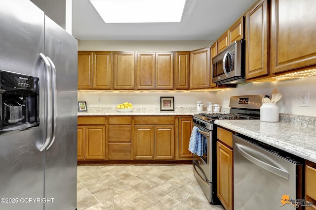 kitchen featuring brown cabinets and stainless steel appliances