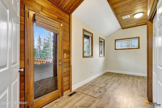 entryway featuring wood ceiling, visible vents, vaulted ceiling, light wood-type flooring, and baseboards
