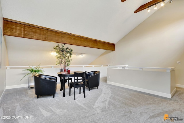 dining room featuring carpet, baseboards, lofted ceiling with beams, and rail lighting