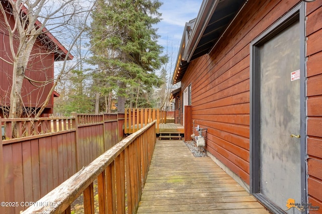 view of property exterior with a deck and fence