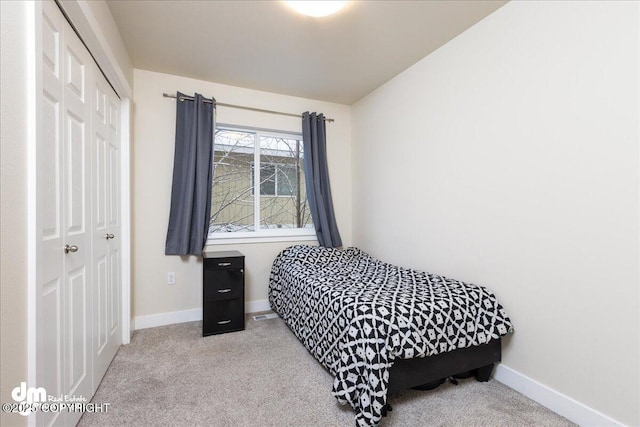 bedroom with light colored carpet and a closet