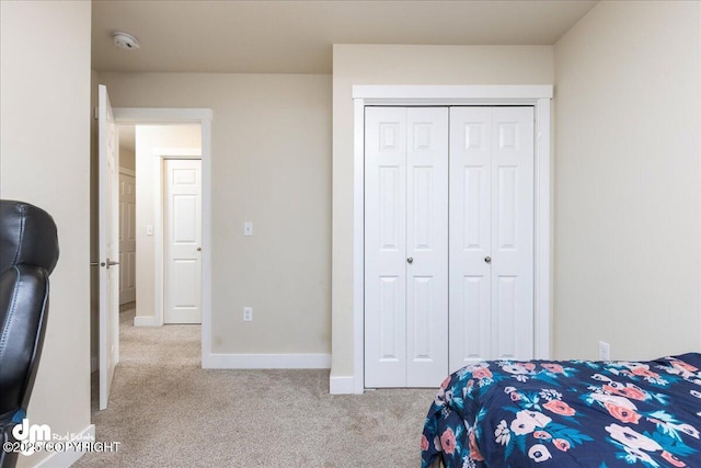 bedroom featuring light colored carpet and a closet