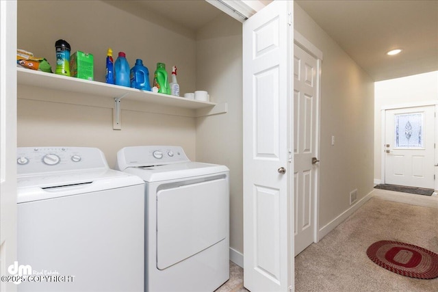 laundry area featuring separate washer and dryer and light carpet