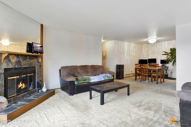 living area with carpet floors and a stone fireplace