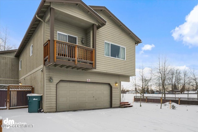 exterior space featuring a balcony and a garage