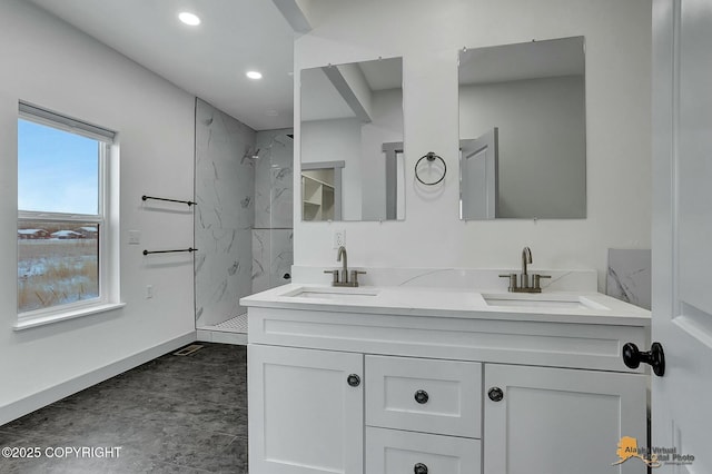 bathroom with vanity and tiled shower