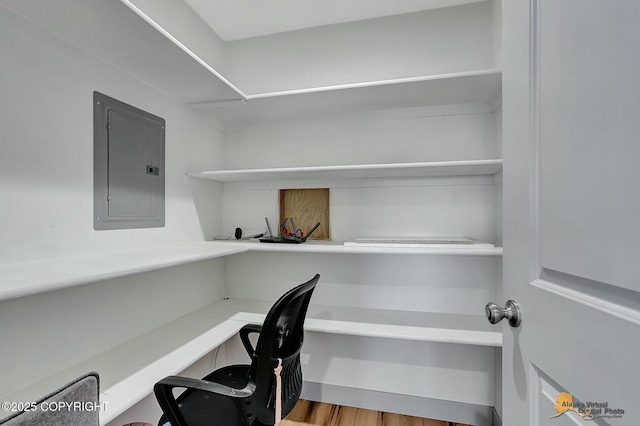 office area with hardwood / wood-style flooring and electric panel