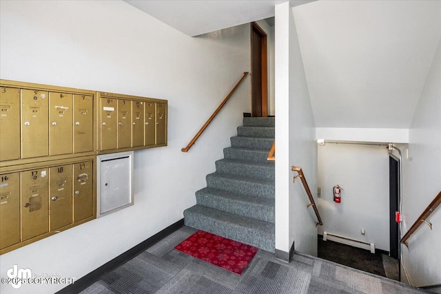 staircase featuring a baseboard radiator, carpet, and a mail area