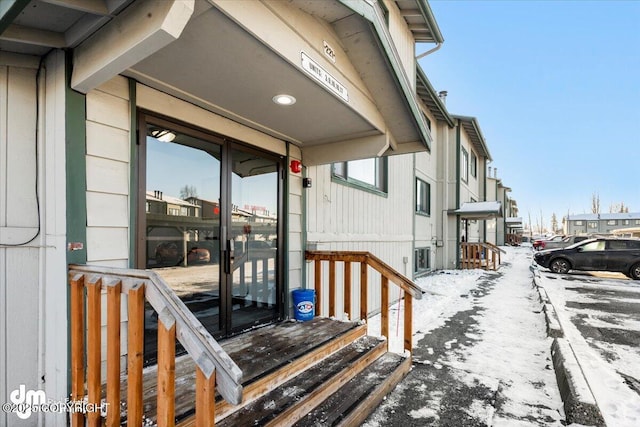 view of snow covered property entrance