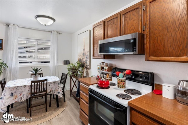 kitchen with range with electric cooktop and light hardwood / wood-style flooring