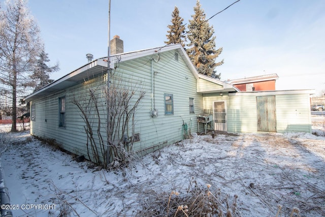 view of snow covered house