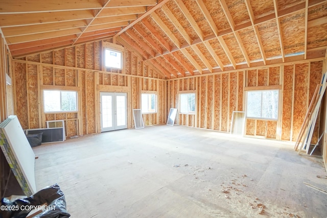 miscellaneous room featuring a wealth of natural light, high vaulted ceiling, and french doors