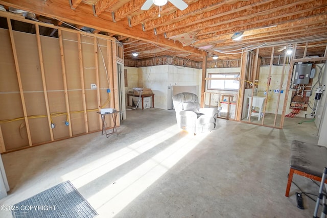 basement featuring water heater and ceiling fan