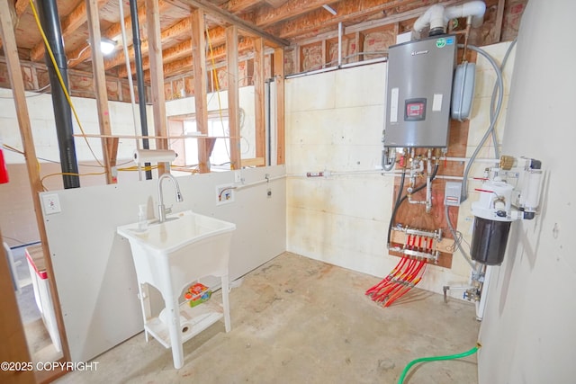 utility room with water heater and sink