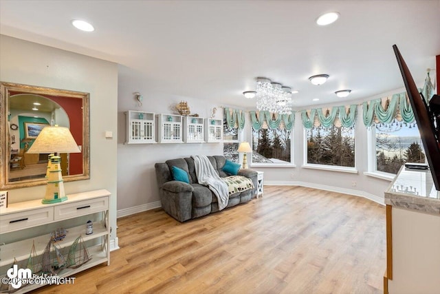 sitting room featuring light hardwood / wood-style floors and a notable chandelier