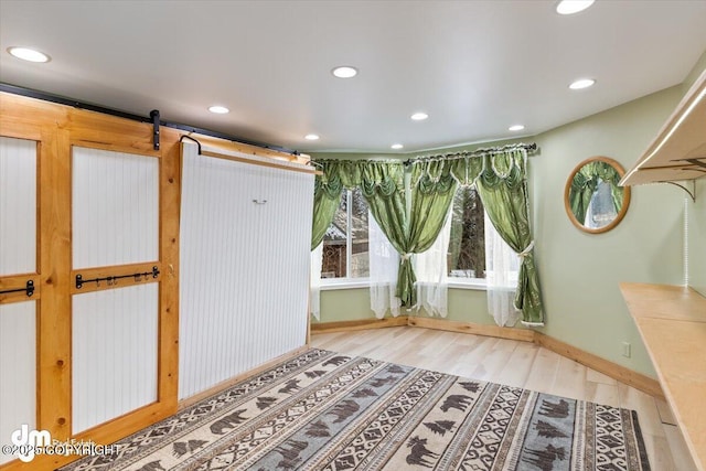 interior space featuring a barn door and hardwood / wood-style floors