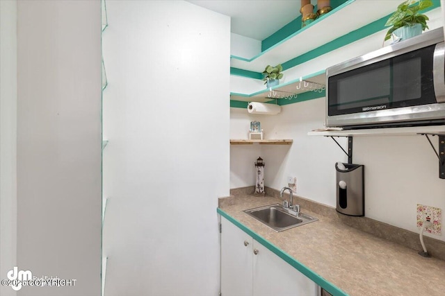 kitchen with white cabinetry and sink