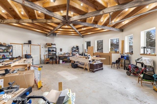 misc room with lofted ceiling and a workshop area