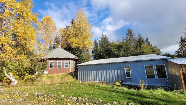 view of side of property with a yard