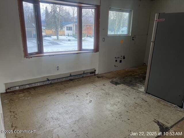 unfurnished room with baseboard heating