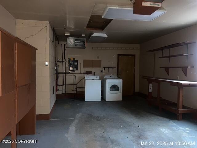 garage featuring washer and clothes dryer and electric panel