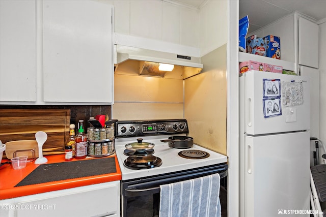 kitchen with range with electric stovetop, tasteful backsplash, white fridge, and white cabinets