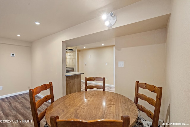 dining area featuring dark wood-type flooring