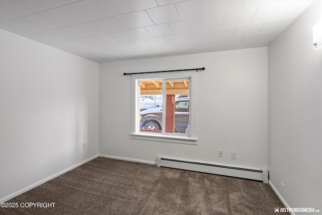 carpeted empty room with a baseboard heating unit