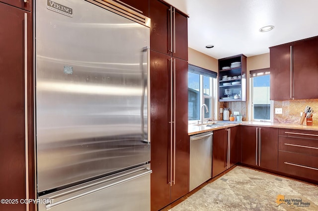 kitchen with sink, decorative backsplash, and appliances with stainless steel finishes