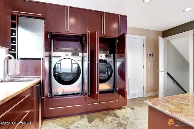 laundry area featuring washer / clothes dryer and sink