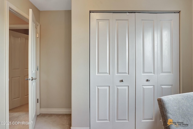 unfurnished bedroom with light carpet and a closet