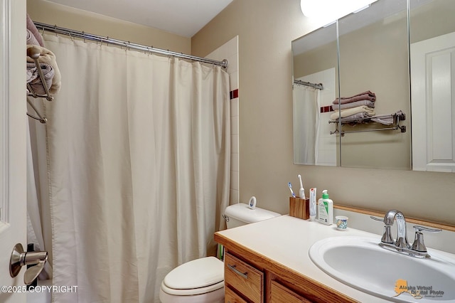 bathroom featuring walk in shower, vanity, and toilet