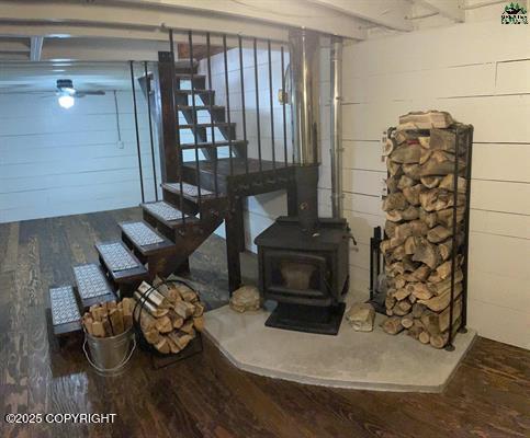 interior space with hardwood / wood-style flooring and a wood stove