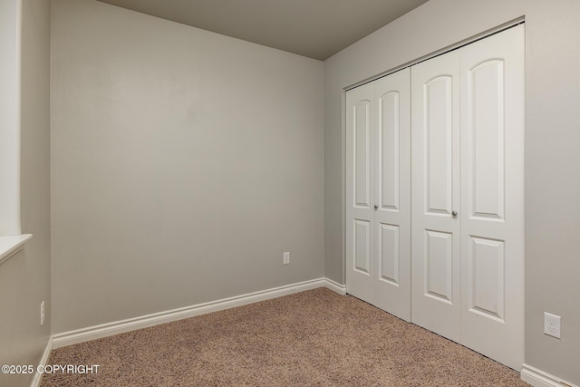 unfurnished bedroom with a closet and carpet